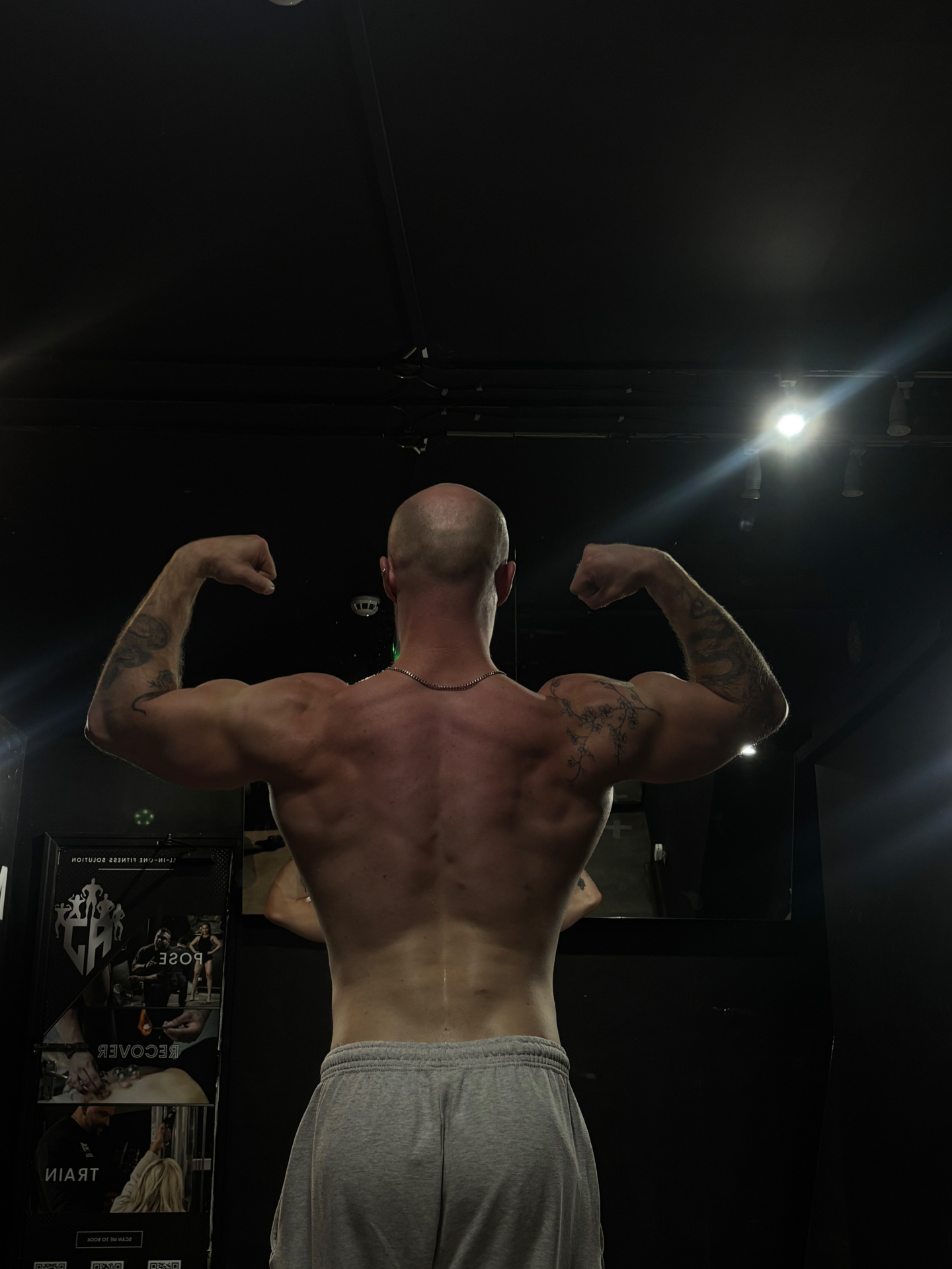 Back double biceps pose showing developed lats and arms